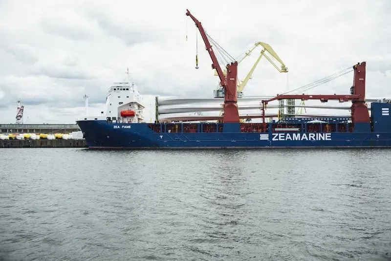 Cargo ship equipped with deck cranes at a port