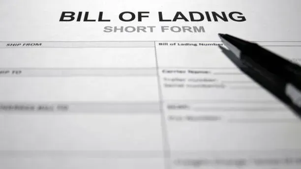 Bill of lading form beside a pen