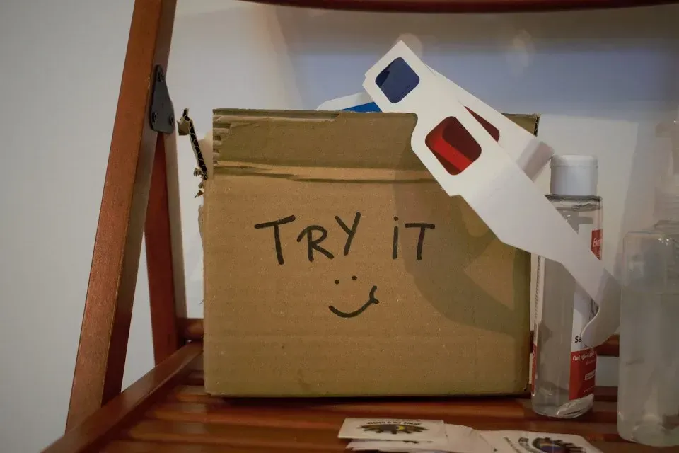 Cardboard box marked Try It with paper 3D glasses attached
