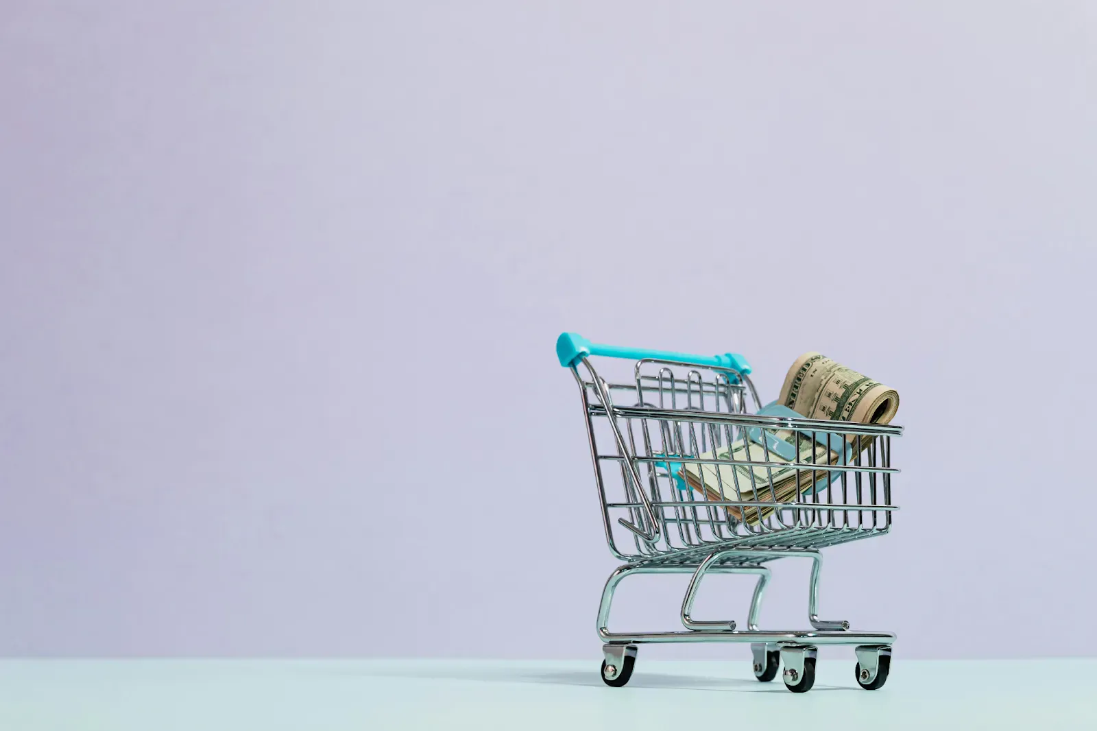 Miniature shopping cart holding banknotes
