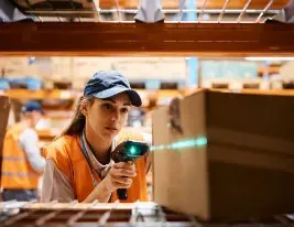 Warehouse worker scanning the barcode on a box